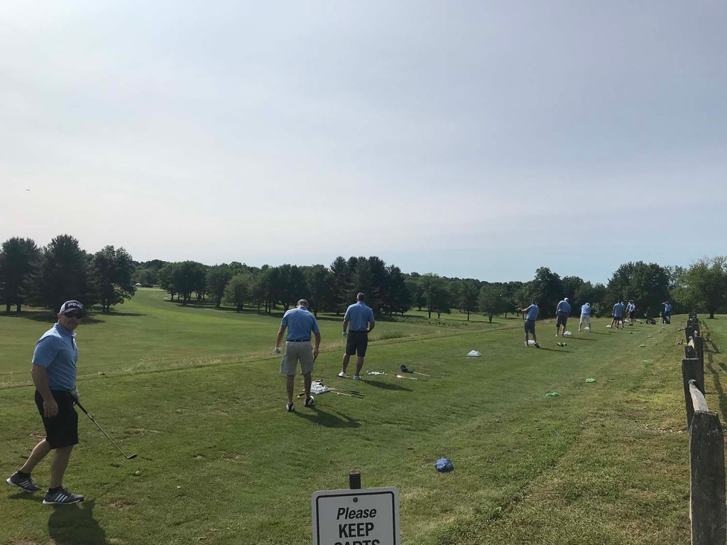 golfers at the driving range