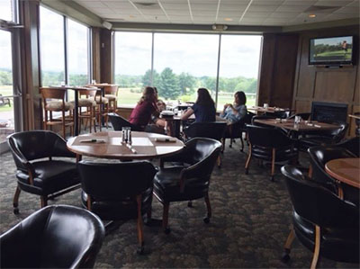 guests at a table facing the course