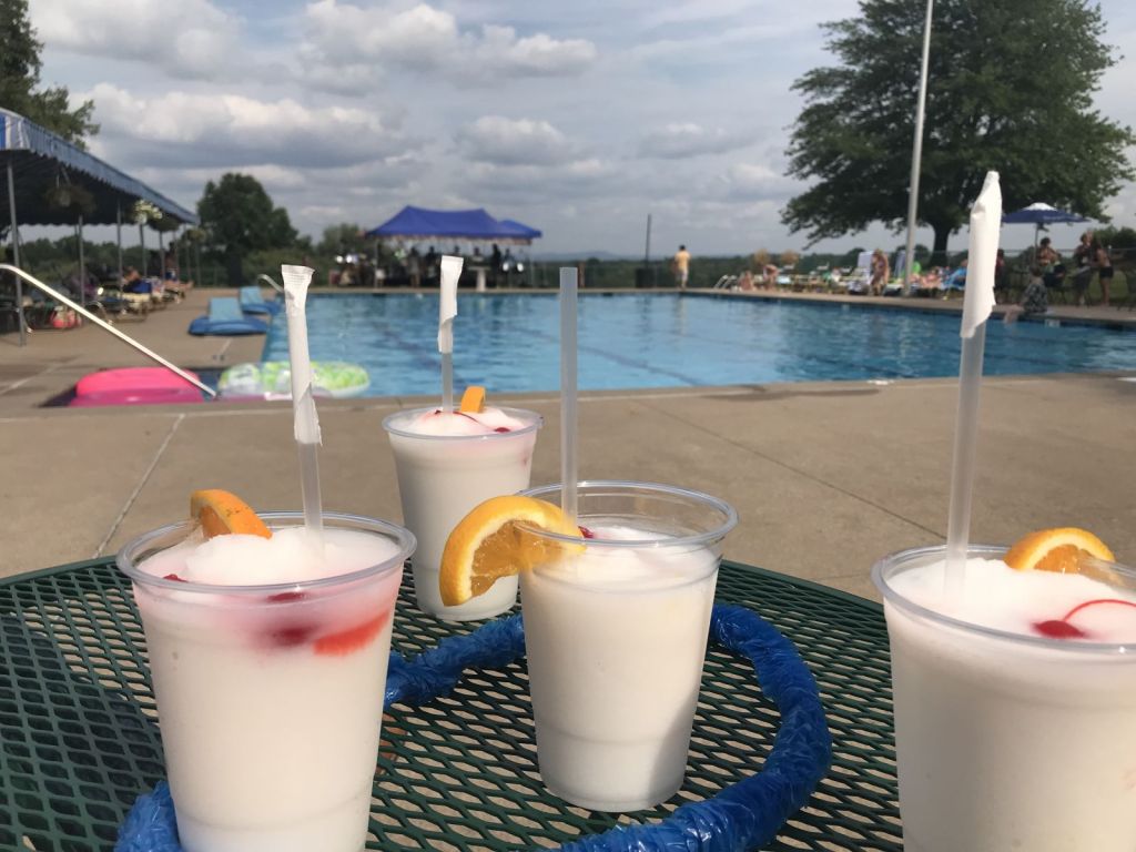 cold drinks on a table by the pool